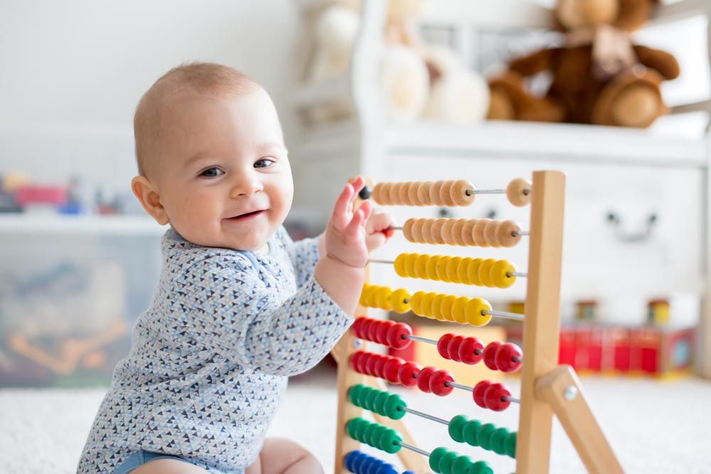 Baby playing with abacus
